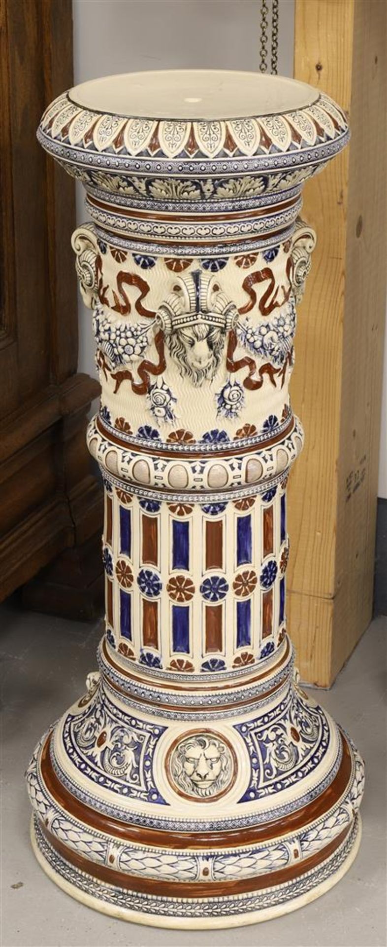 A cylindrical stoneware pedestal, Germany, early 20th century. Decor of ram heads, garlands and - Image 2 of 3