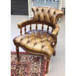 An oak office chair with green padded leather upholstery, 20th century.