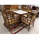 A square Art Nouveau coffee table with four matching chairs, early 20th century. Walnut, white