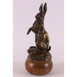 Mason, Clovis (France 1838-1913) A brown patinated bronze hare on wooden base, France ca. 1900.