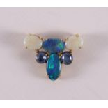 A 14 kt 585/1000 pendant, set with oval cabochon cut opals, gross weight 7.5 grams, length 3.5 x w