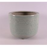 A celadon-coloured porcelain brush pot, China, Kangxi, around 1700. Relief floral decoration, h 13 x