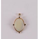 An oval 18 carat 750/1000 gold pendant, set with oval cabochon cut opal, gross weight 3.8 grams, l 3