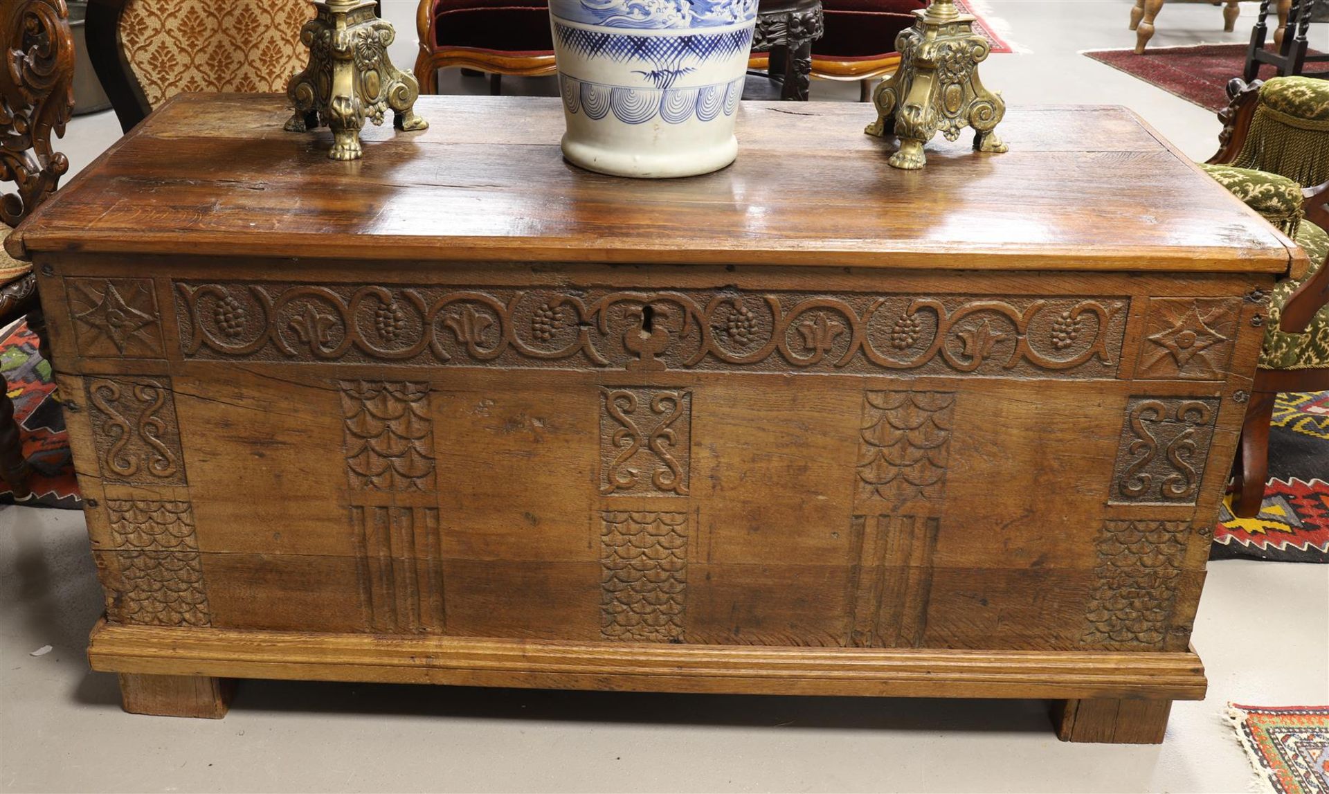 A blanket chest with flat lid, 18th century. Front with letter panels with carved decor of grape