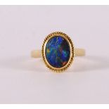 A 14 kt 585/1000 yellow gold entourage ring, set with cabochon cut oval opal, gross weight 6.1