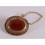An oval 14 carat 585/1000 gold brooch, set with galacinated carnelian, around 1900. Gross weight 6.2