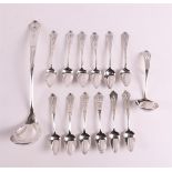 A series of eleven 2nd grade 835/1000 silver Art Deco teaspoons and cream spoon + bowl spoon,