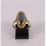 A 14 kt 585/1000 yellow gold entourage ring, set with oval faceted garnet, gross weight 3.8 grams,