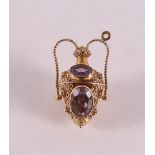 An 18 kt 750/1000 yellow gold amphora-shaped pendant, set with four oval faceted sapphires, gross