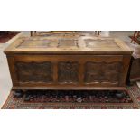 A blanket chest with flat lid, 18th century. Oak wood, lid with contoured panels, front with carving