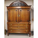 A two-door cabinet, Northern Netherlands, early 19th century. Oak wood, curved profiled hood with