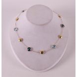 An 18 kt 750/1000 gold women's necklace with facet cut colored stones, marked Italo Bottene.