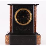 A mantel clock in black marble housing, France, circa 1900. Dial with Roman numerals, h 28 cm (top