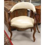 A curved mahogany desk chair, Dutch, Willem III, 19th century. Beige skai upholstery of a later