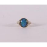 A 14 kt 585/1000 yellow gold pinky ring, set with opal and an entourage of brilliants, gross