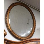 An oval mirror in a profile frame, 19th century, h74 x w62 cm.