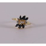 An 18 kt 750/1000 gold fantasy ring with 6 brilliants of 0.27 ct in total and 6 marquise cut blue