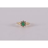 An 18 carat 750/1000 gold ring with a facet cut emerald and 8 brilliants. Ring size 17.25 mm.