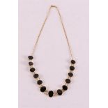 A 14 kt 585/1000 yellow gold necklace with oval cabochon cut onyx, gross weight 17.0 grams, length