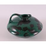 Netherlands, Eskaf. A green and black spotted earthenware so-called discus jug, design: W.H. van
