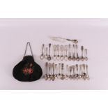 A lot of various mainly 2nd grade 835/1000 silver spoons. Hereby sugar tongs and bag handle on
