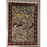 An Oriental carpet with a polychrome decoration of birds and flora, l 190 x w 124 cm.