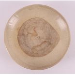A cream stoneware dish, China/Annam Vietnam, Ming, 15th century, h 5 x Ø 26.5 cm.