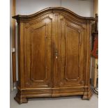 A two-door cabinet, Southern Netherlands, 1st half 18th century. Oak, curved profiled hood,