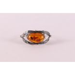 A 1st grade 925/1000 silver rigid bracelet with cabochon cut amber, mid 20th century.