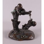 A bronze sculpture of children playing in a tree, China, 19th century, h 13.5 cm.