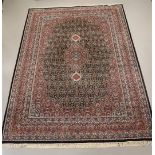 An Oriental wool carpet with blue background, Iran, Ind-Bidjar, l 355 x w 255 cm.