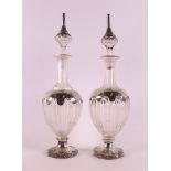 A set of clear glass decanters with 2nd grade 835/1000 silver mount, around 1900, h 40 cm, tot.