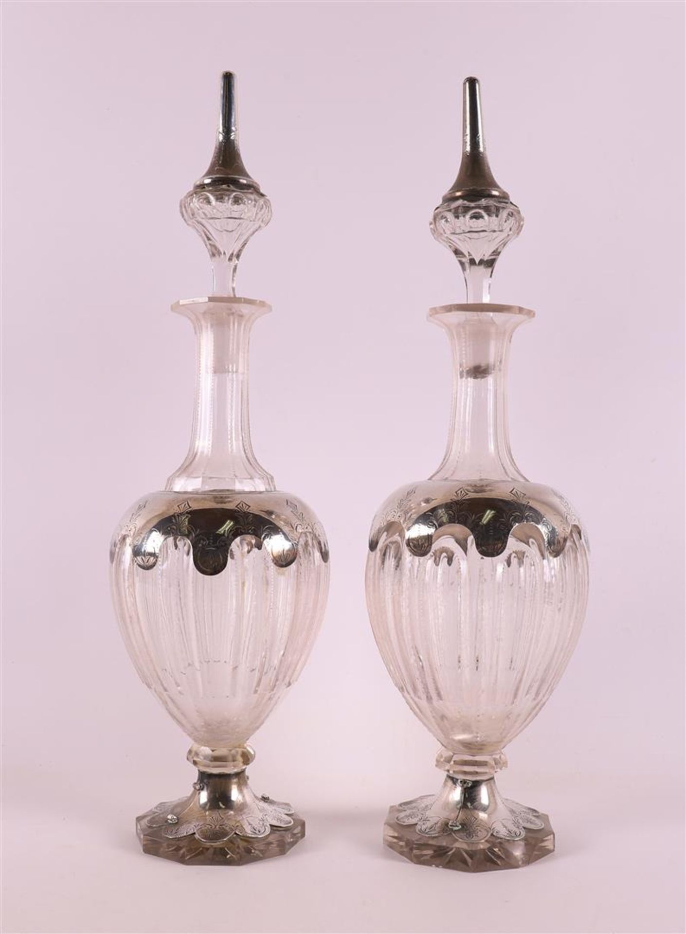 A set of clear glass decanters with 2nd grade 835/1000 silver mount, around 1900, h 40 cm, tot.