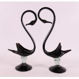 A pair of black glass swans on baluster-shaped trunk and round foot, Italy, Murano, 2nd half 20th