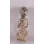 Ethnography. A stone ancestral statue of a kneeling woman, Africa, 20th century, h 34 cm.