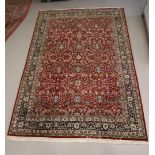 An Oriental wool carpet with a round background and floral motifs, length 320 x w 206 cm.