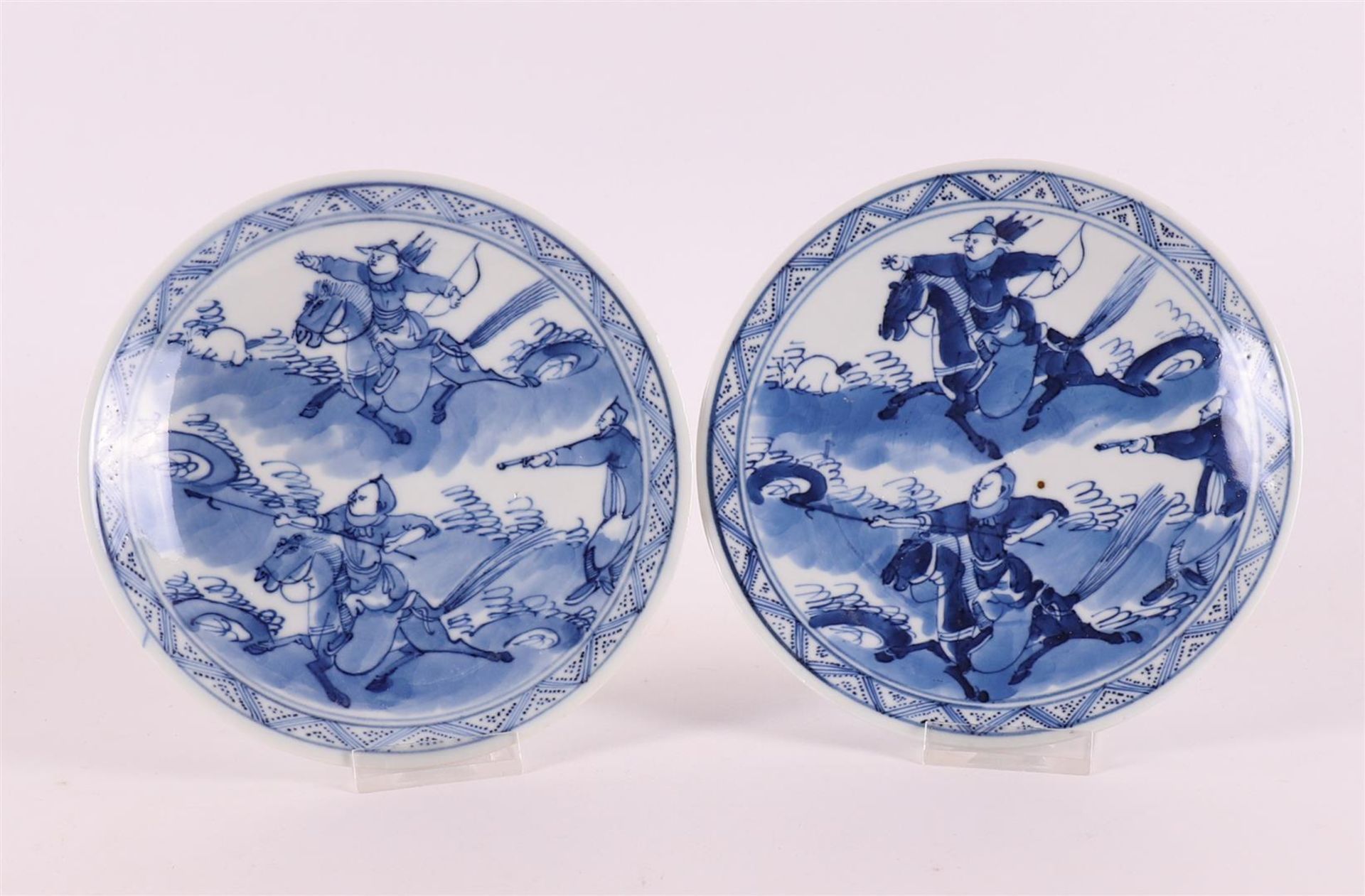 A pair of blue and white porcelain plates, China, 19th century. Blue underglaze decoration of '