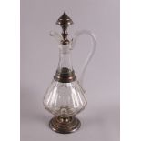 A clear glass carafe with silver mounting, 1st half 20th century. Decor of facet and olive cut, h 35