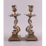 A pair of single-light candlesticks, after an antique example, 20th century. Leaf-shaped cuppa,