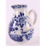 A blue and white porcelain milk jug, China, Qianlong 18th century. Blue underglaze decoration of a.