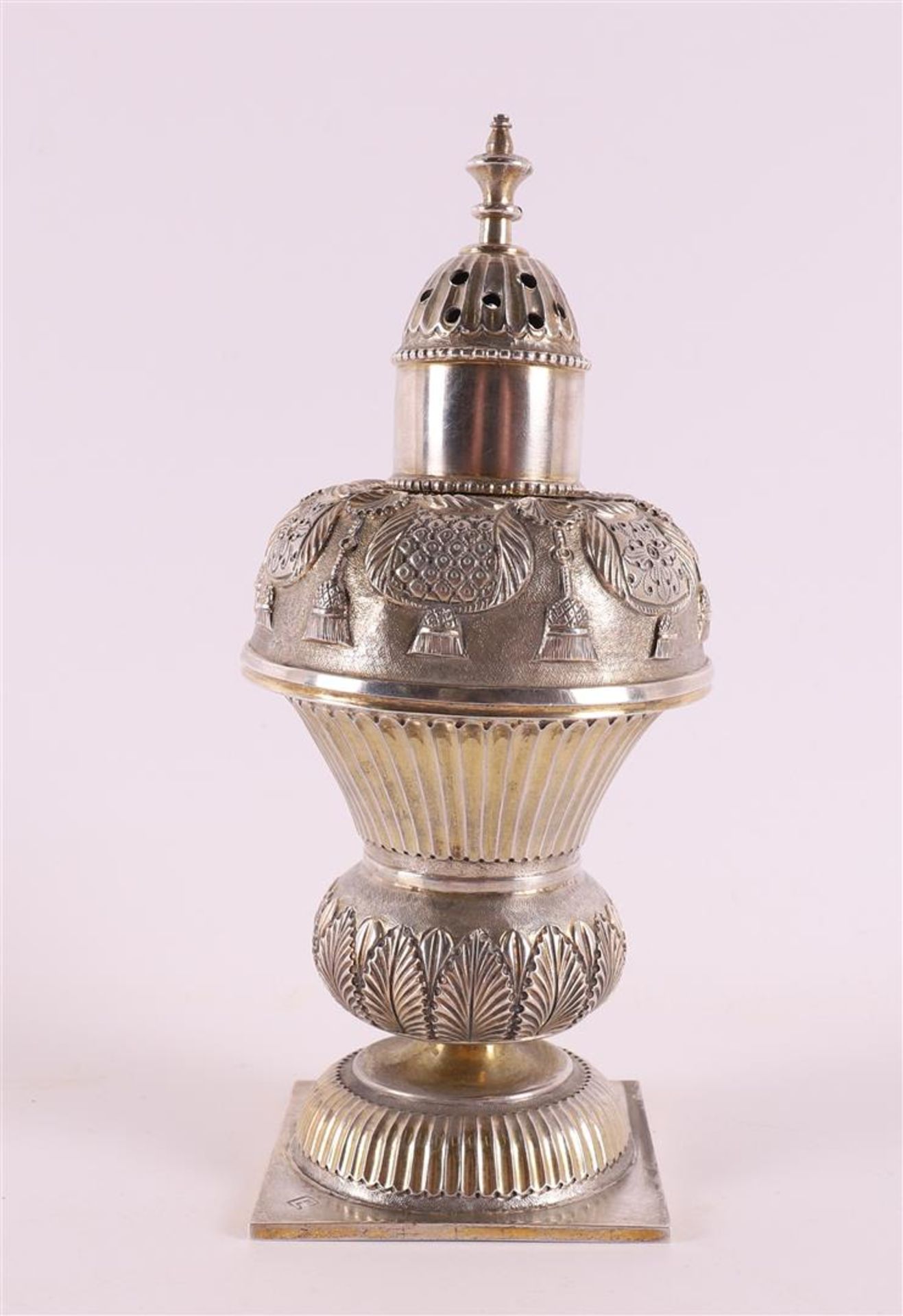 A silver sugar shaker, after an 18th century example, 19th century or later. Driven decoration of,