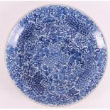 A blue and white porcelain dish, China, Kangxi, around 1700. Blue underglaze of peonies and grapes
