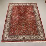An Oriental wool carpet with a round background and floral motifs, length 340 x width 24 cm.