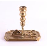 A bronze button candlestick with snout, 19th century. Candle mouth transitioning into the trunk with