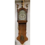 A Frisian tail clock, Friesland, mid 19th century. Oak case, the curved hood is crowned by Atlas and