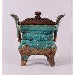 A rectangular blue/green glazed earthenware cencer with handles and wooden cover of later date,