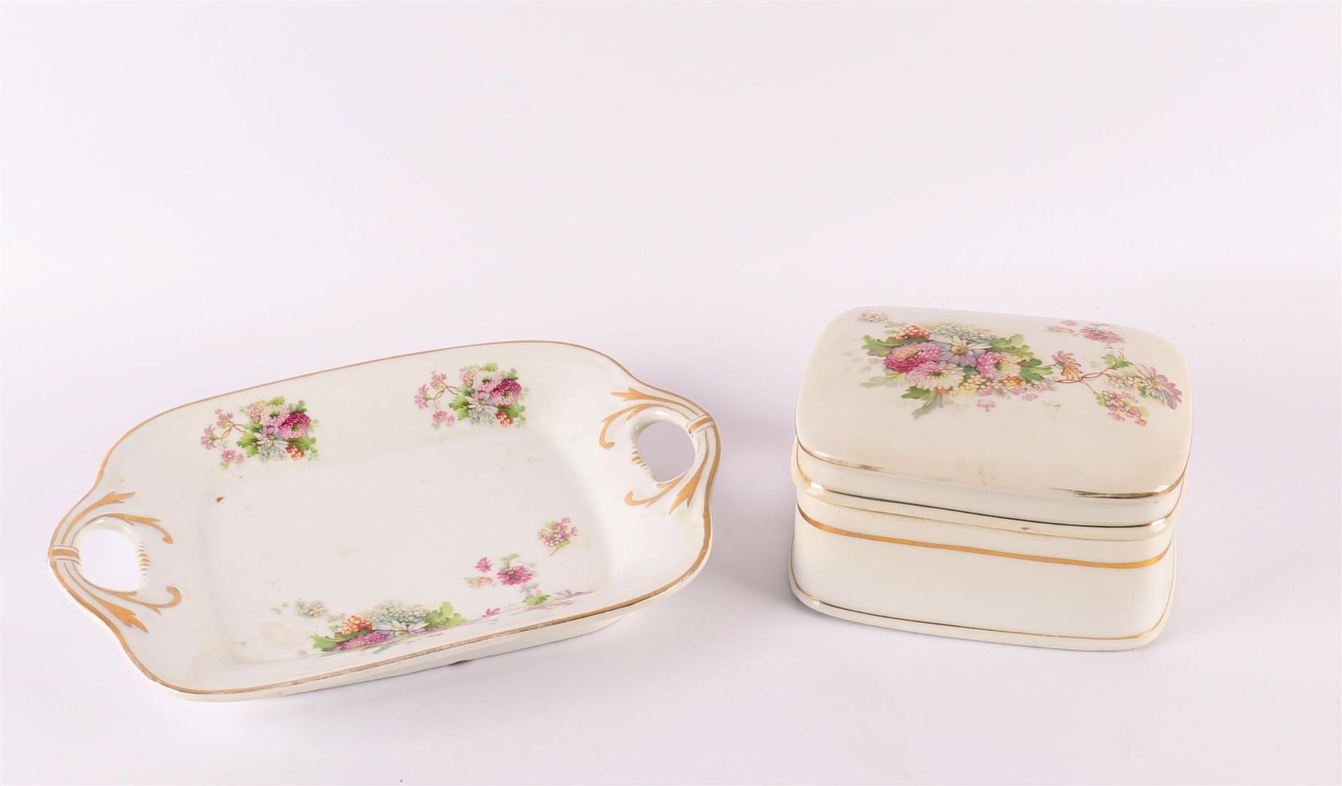 A rectangular porcelain box with lid on a base, 19th century. Polychrome floral transfer decor, h 11