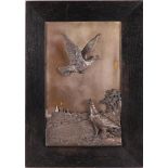 A silver-plated brass relief depicting pheasants with a cityscape in the background, France around