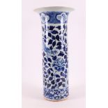 A cylindrical blue and white porcelain trumpet vase, China, 19th century. Blue underglaze floral