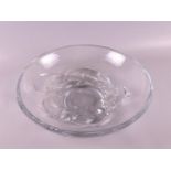 A clear thick-walled glass dish with relief decoration of dolphins, France mid 20th century, h 9 x Ø